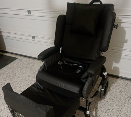 A black wheelchair featuring a footrest